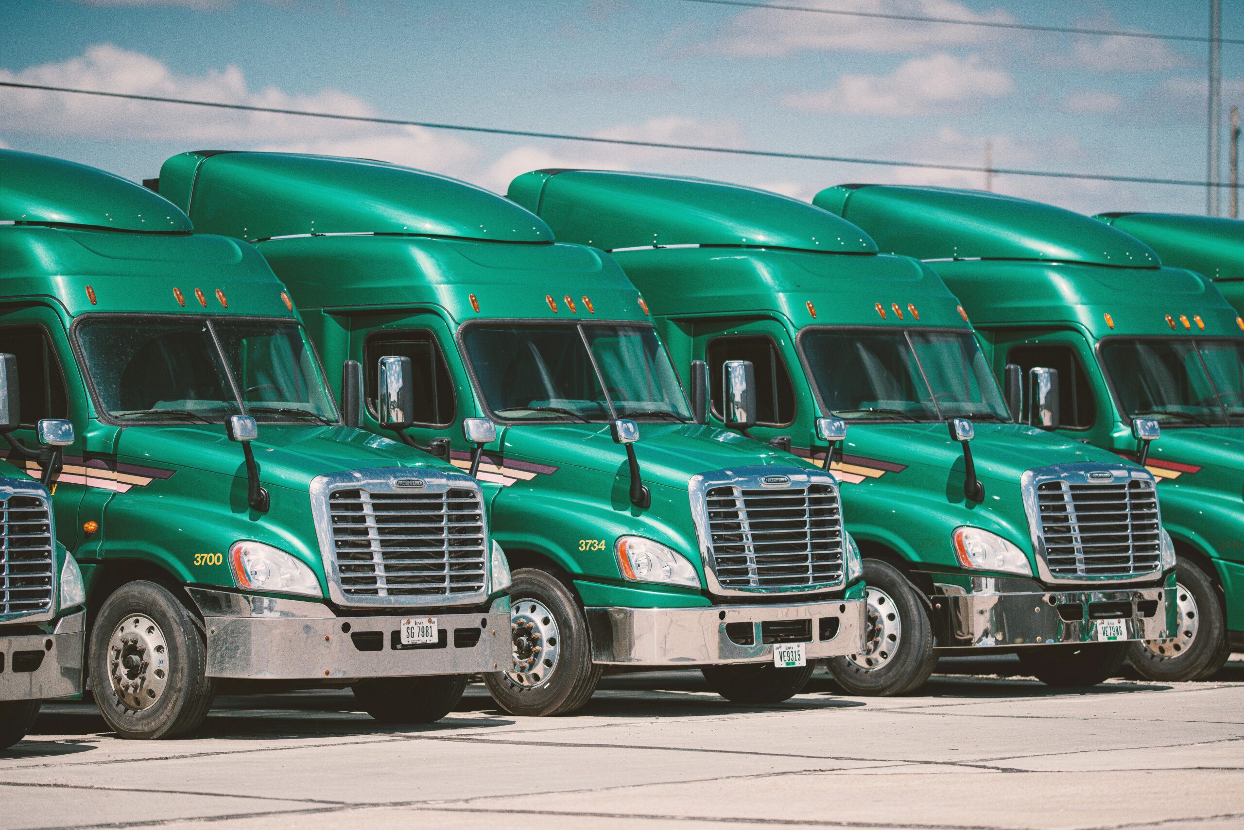a fleet of green trucks