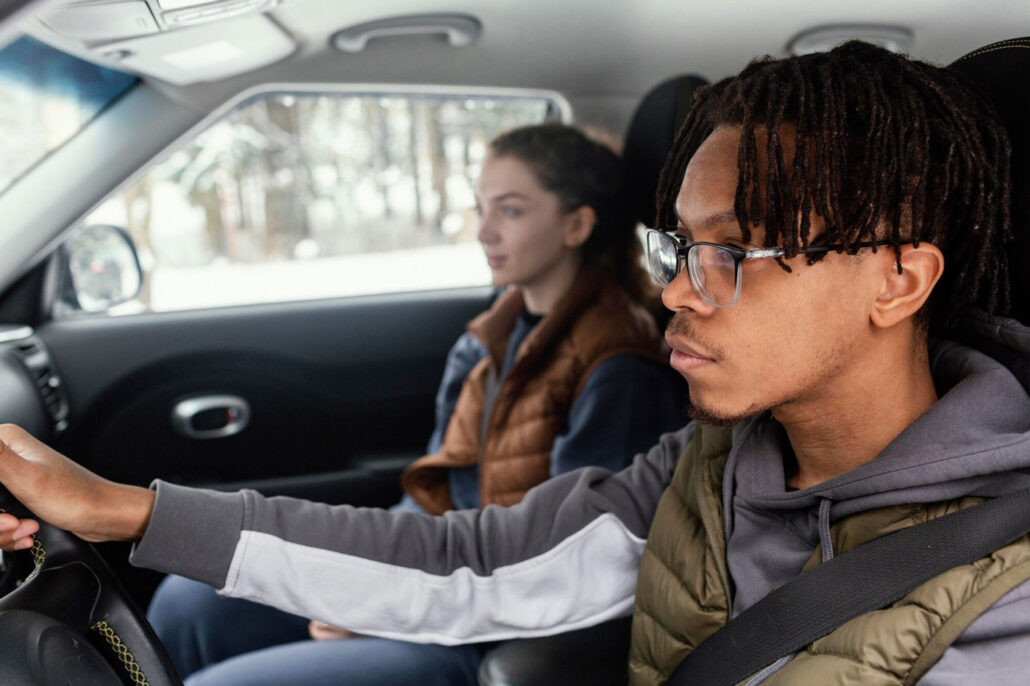 Two teenagers in a car.